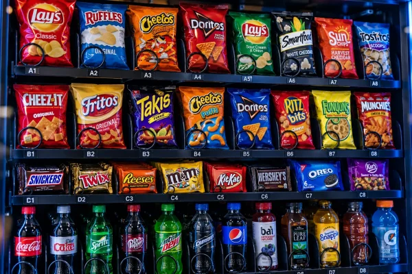 Sleek vending machine stocked with snacks-1
